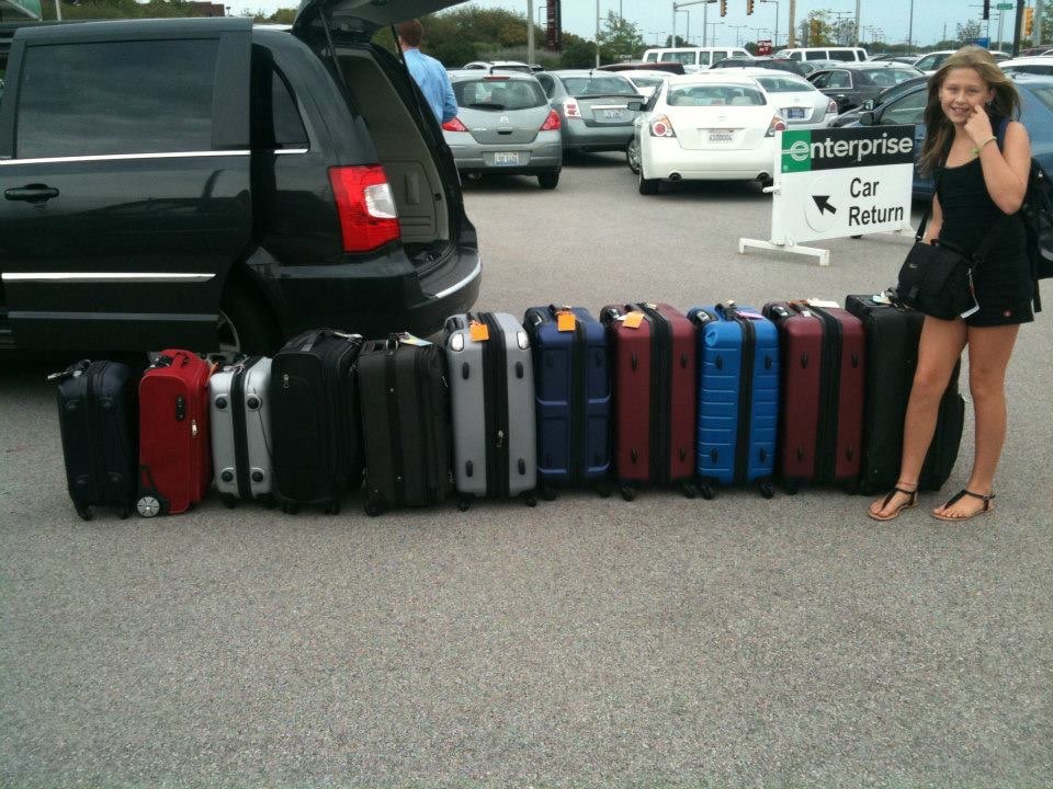 a girl with many many suitcases
