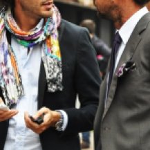 That is a man wearing the floral scarf. Italian men are not afraid of color or patterns. Photo: tommy-tons-street-style-men-of-milan-4-494x341.jpg