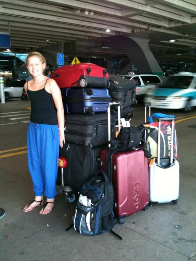 a girl with a lot of suitcases