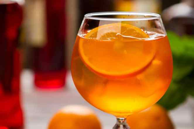 Orange drink in wineglass.