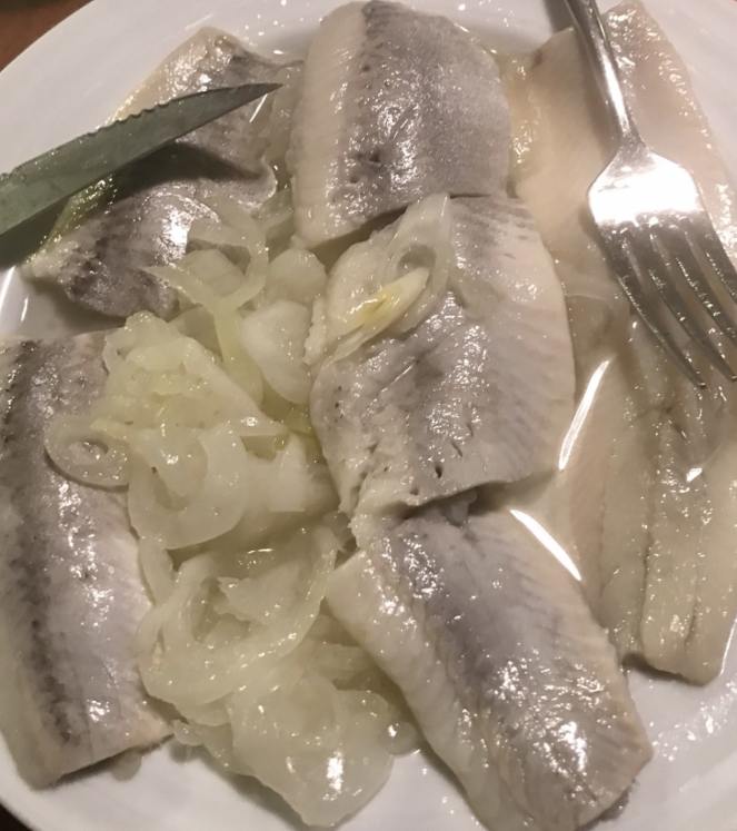 a plate of herring and onions