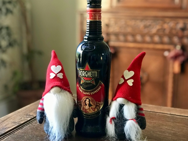 Two Christmas gnomes with a bottle of Borghetti.